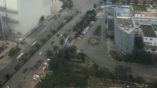An aerial view of a cityscape with various buildings, roads, and a large open plaza. - X-Stay Bloom (Hai Phong)