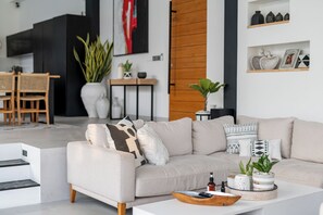 A modern living room with a sofa, coffee table, and decorative items. - Villa Bali Escape– Private Ricefield Retreat, Steps from the Canggu Action (Canggu)