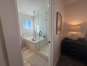 A modern bathroom with a glass-enclosed shower, a white sink, and a dark wooden vanity. - Cozy Winter Escape, New Build with 3 Car Garage (Tooele)