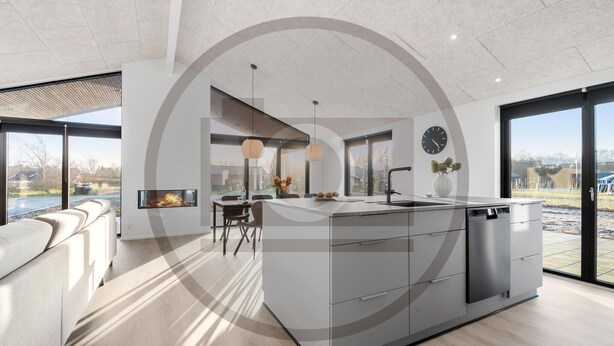 A modern kitchen with a central island, large windows, and a dining area. - Amazing home in Hemmet with sauna (Hemmet)