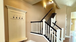 A staircase with white railings and a wooden floor. - Baldwin Retreat | Spacious Stay w/ 3 King Beds (Meridian)