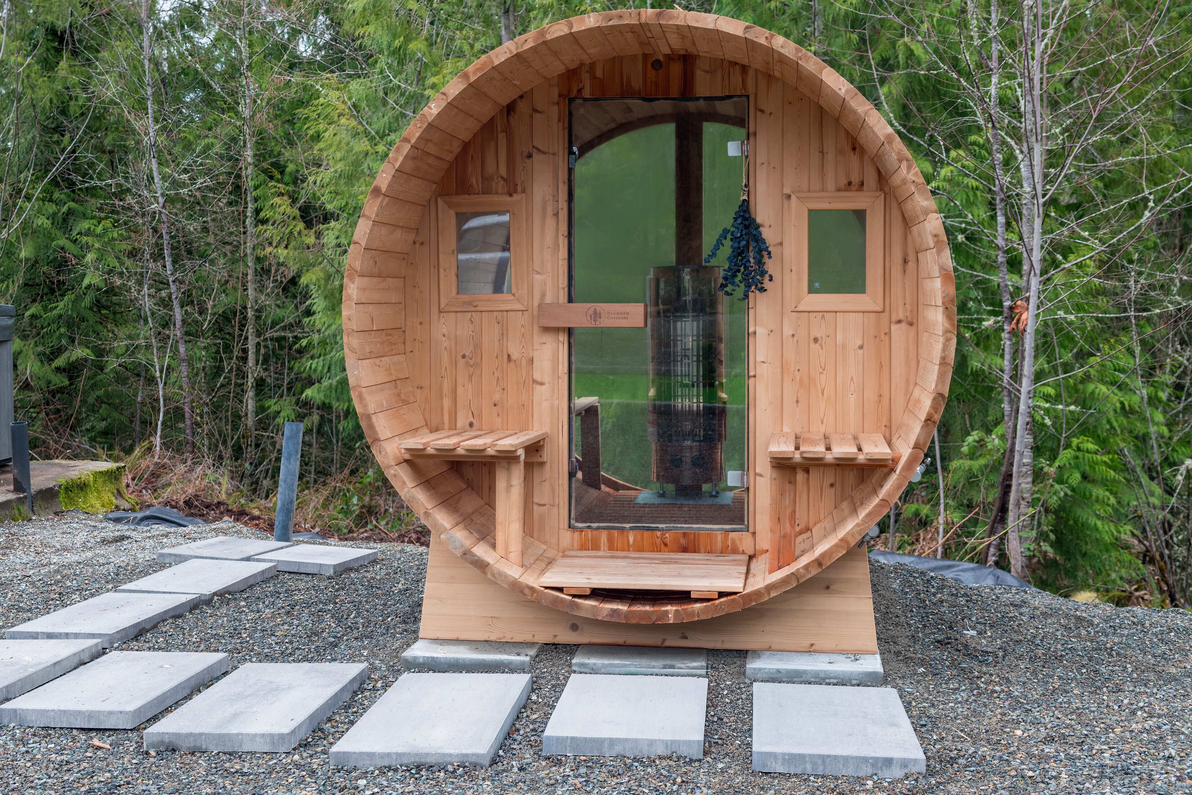 A wooden cabin with a circular door, a small window, and a doorbell.