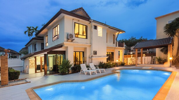 A two-story house with a swimming pool, outdoor seating, and a well-lit patio area. - First Private Pool Villa, 4-bedroom private pool villa in peaceful Ao Nang, (Ao Nang)