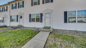 A two-story building with a front entrance, a small porch, and a pathway leading to the door. - 5 Mi to Cave Tour! Couples Adventure Hub (Bowling Green)