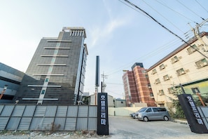 A modern building with a sign indicating a business center. - Prima Hotel (Seosan)