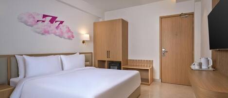 Una habitación de hotel con cama, armario de madera, televisor e iluminación en la pared.