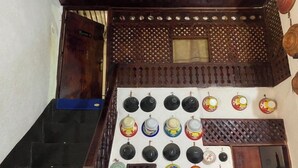 A staircase with a wall-mounted display of various ceramic plates and bowls. - Traditional Guest House  (Harar)