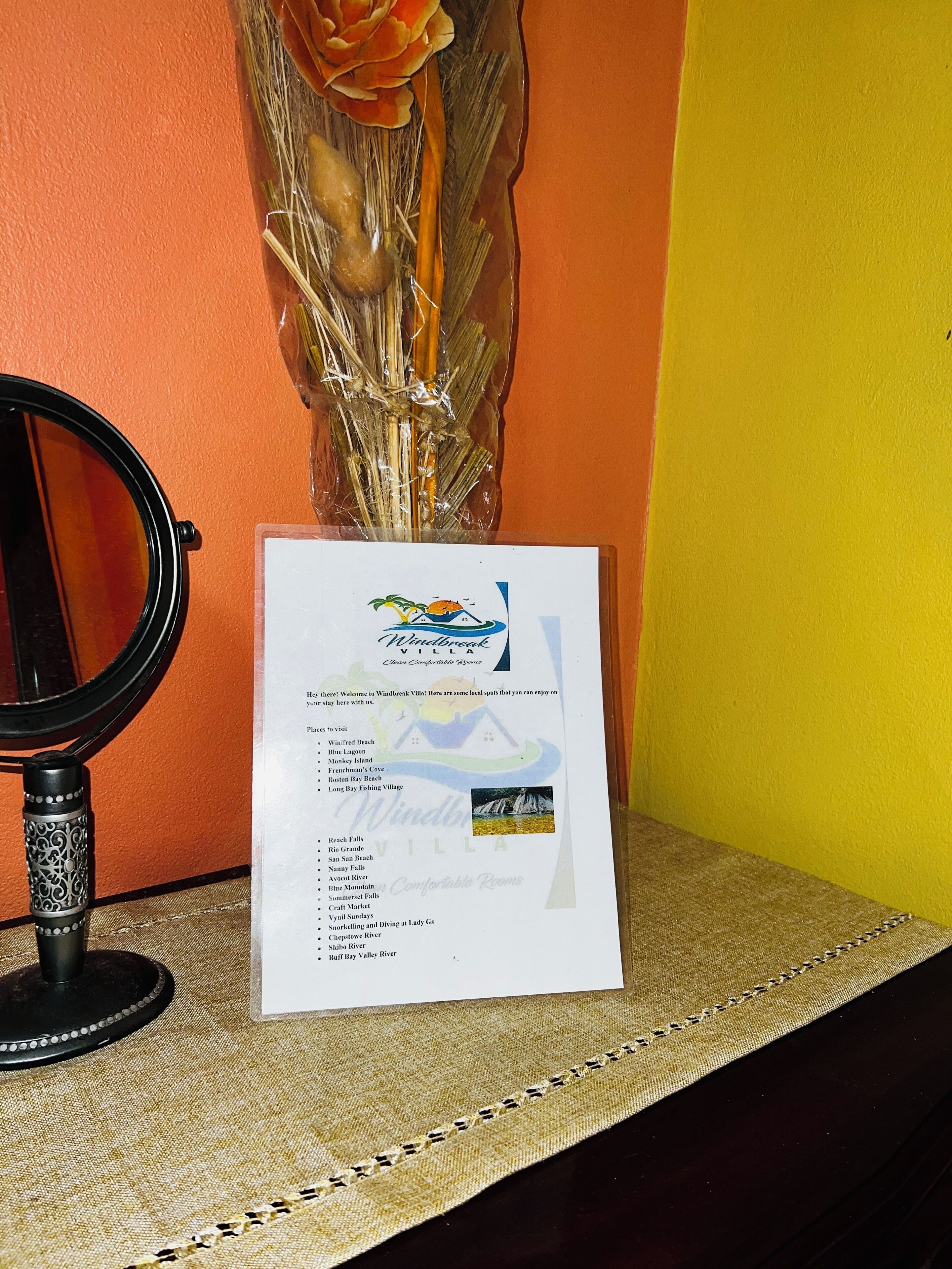 A brochure for Windbreak Villa, listing local attractions like Blue Lagoon and Monkey Island.