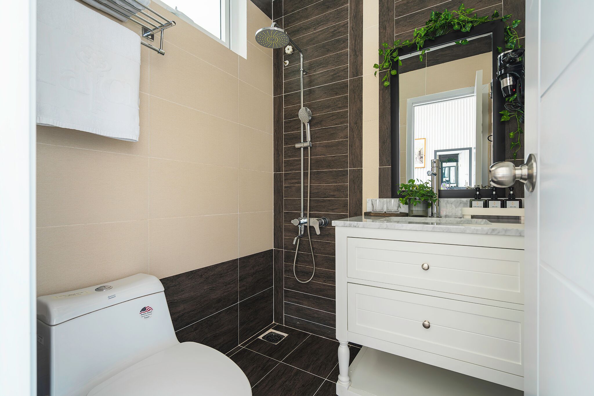 A modern bathroom with a shower, toilet, and vanity.