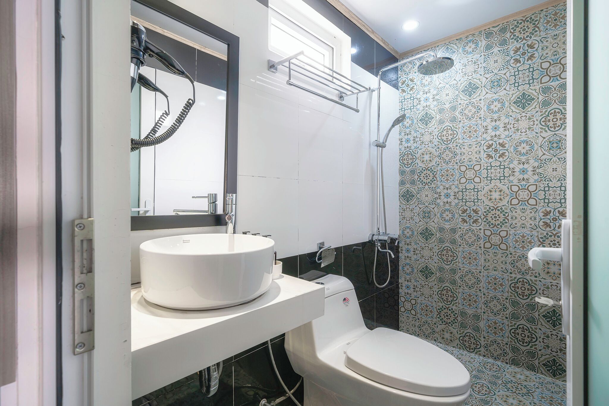 A bathroom with a white sink, a toilet, and a shower.