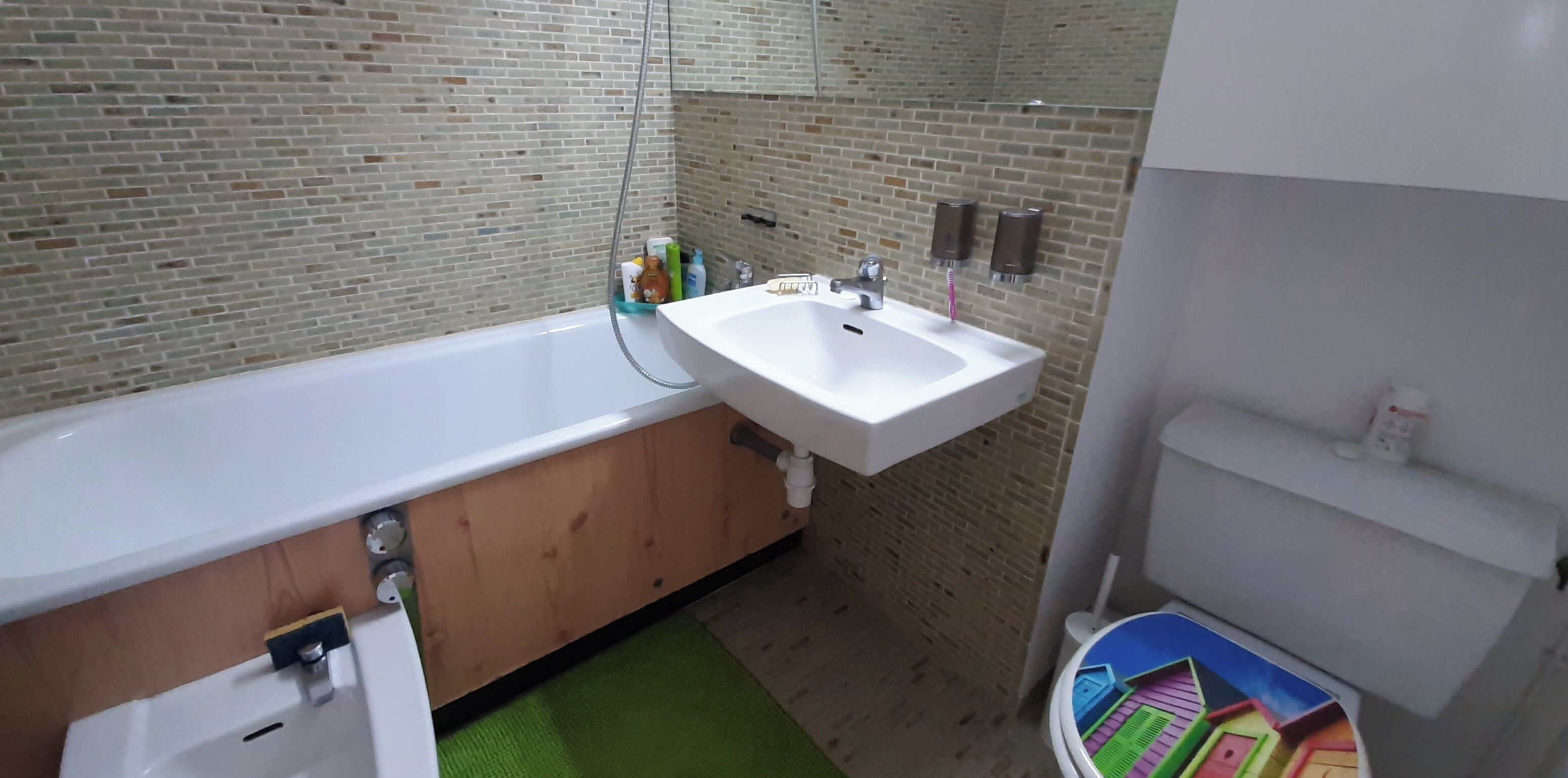 A bathroom with a bathtub, a sink, and a toilet.