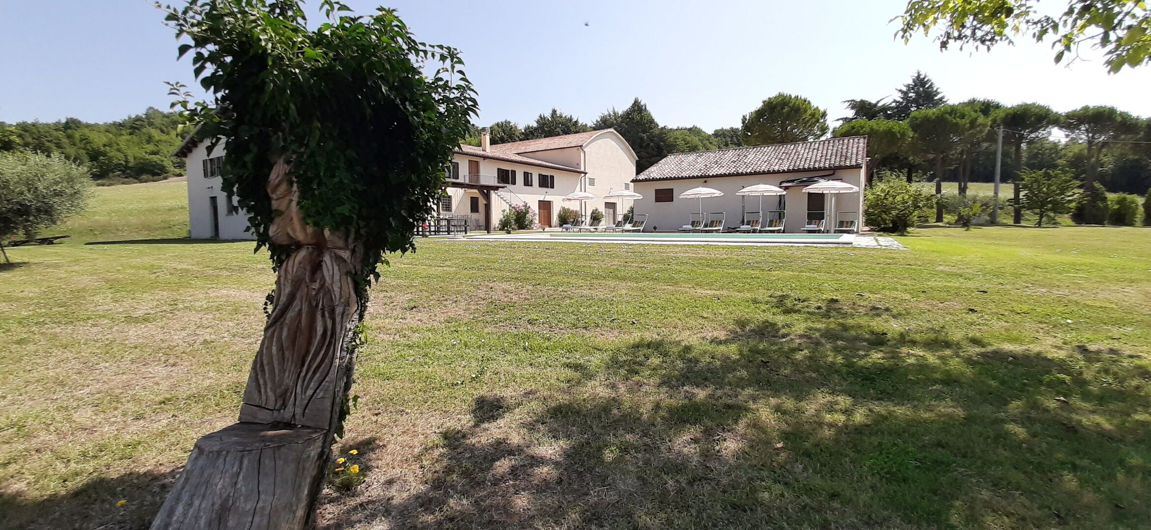A large building with multiple rooms and a swimming pool.