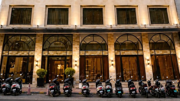 A multi-story hotel with a uniform facade, air conditioning units on each window, and a row of parked scooters in front. - Konaark's Arka Hotels Nagpur  (Nagpur)