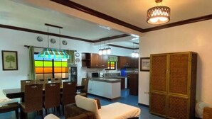 Un espace de vie compact comprenant un coin repas, une kitchenette et un canapé.