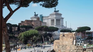 A historic building with classical architecture, a large open plaza, and surrounding trees. - Stylish 2-Bedroom Stays near Colosseum (Rome)