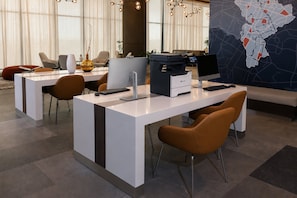 A modern office space with desks, chairs, computers, and a large map on the wall. - Holiday Inn Express And Suites Monterrey Sendero (Escobedo)