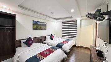 Deluxe Triple Room, City View | Laptop workspace, blackout drapes, soundproofing, free WiFi