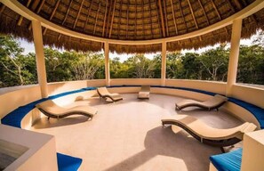 A circular outdoor lounge area with lounge chairs and a thatched roof. - CASA PRINCE, private pool, 4 bedrooms (Puerto Morelos)