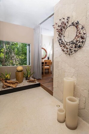 A modern bathroom with a large window, a decorative wall piece, and a wooden floor. - PENTHOUSE PRINCE, loft & rooftop jaccuzi spa (Puerto Morelos)