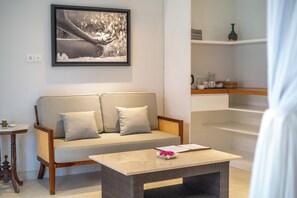 A modern living room with a sofa, a coffee table, and a framed picture on the wall.