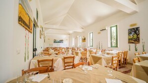A spacious dining area with multiple tables and chairs, arranged in rows. - Family Village M7 Pool And Sea (Otranto)