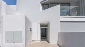 A modern building with a white exterior, a visible entrance labeled "BIK BEACH," and a small balcony with a chair. - CHL Naos del Mar, lovely place pool beach (Los Llanos de Aridane)