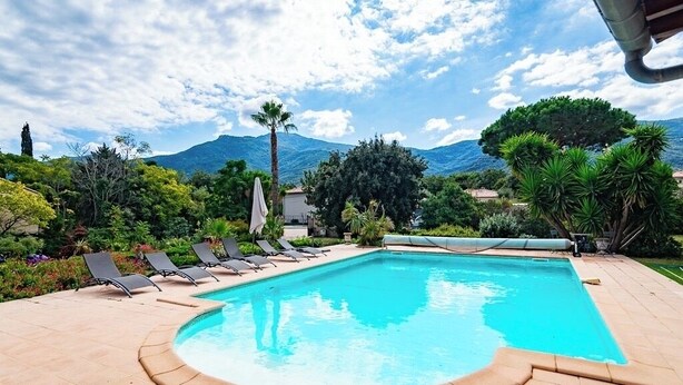 A swimming pool with lounge chairs, surrounded by greenery and mountains in the background. - Luxury villa with amazing views in 3200m2 (Laroque-des-Albères)