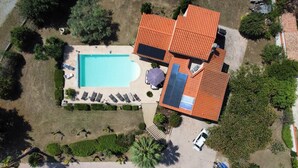 An aerial view of a house with a swimming pool, sun loungers, and a car parked in the driveway. - Luxury villa with amazing views in 3200m2 (Laroque-des-Albères)