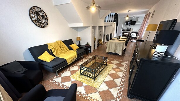 A living room with a sofa, armchairs, a coffee table, and a TV stand. - Charming Cottage in a Converted Farmhouse with Wi-Fi (Vendin-le-Vieil)