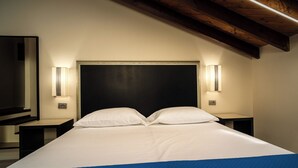 A hotel room with a large bed, two bedside tables, a headboard, and wall-mounted lighting. - Viscuso house (Aci Castello)