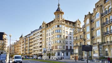 A multi-story building with a classic architectural style, featuring balconies and ornate detailing.