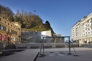 A public square with a playground, benches, and a building with a sign reading "STM San Telmo Museum". - Arraun - Basque Stay (San Sebastián)
