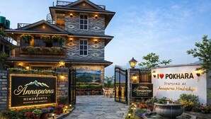 A mountain-view homestay named Annapura HimdriShya with a signboard, a stone pathway, and a garden with a water feature. - Annapurna Himdrishya Pokhara Homestay (Pokhara)