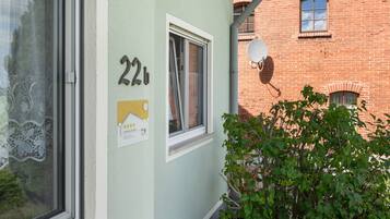 A building with a window, a door, and a number '22' on the wall.