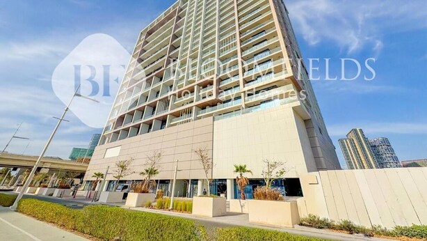 A modern high-rise hotel with a prominent glass facade, multiple balconies, and a landscaped entrance area. - Bloomfileds Executive Studio Al MA (Abu Dhabi)