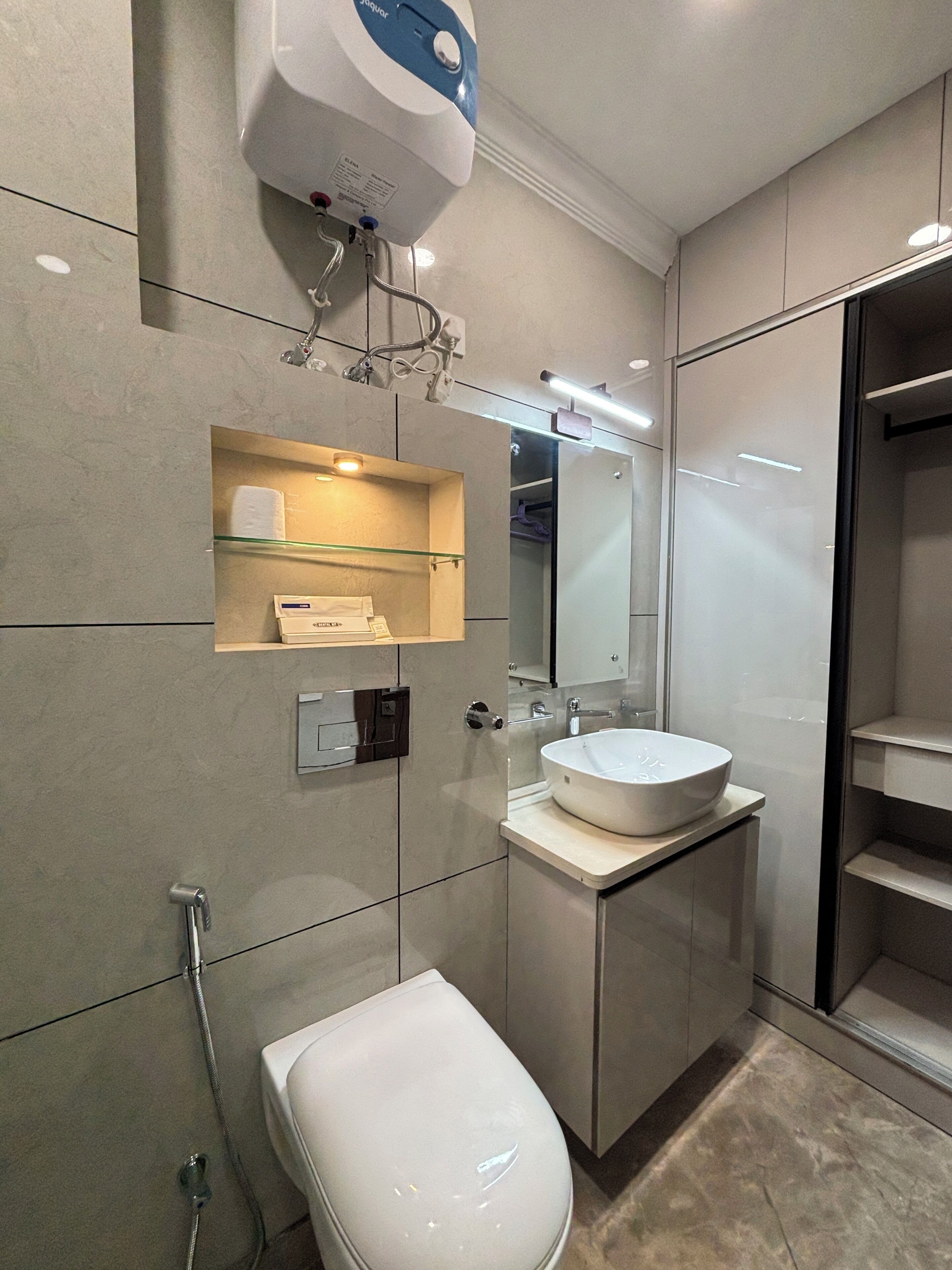 A modern bathroom with a toilet, sink, and shower.