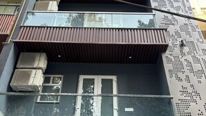 A multi-story building with balconies, air conditioning units, and a metal facade. - Fortune Home Service Apartment 3Bhk J150 (New Delhi)