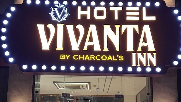 A hotel entrance with a marquee sign reading "HOTEL VIVANTA BY CHARCOAL'S INN". - Hotel Vivanta Inn (Veraval)