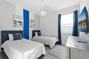 A hotel room with two beds, a television, and artwork on the wall. - Stunning 7BR Retreat, Private Pool, Perfect Location! (Four Corners)