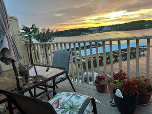 A balcony with a view of a river and boats, featuring outdoor furniture and potted plants. -
Penthouse with an open balcony. Greatest Location, Boat Slip upon request only (Osage Beach)