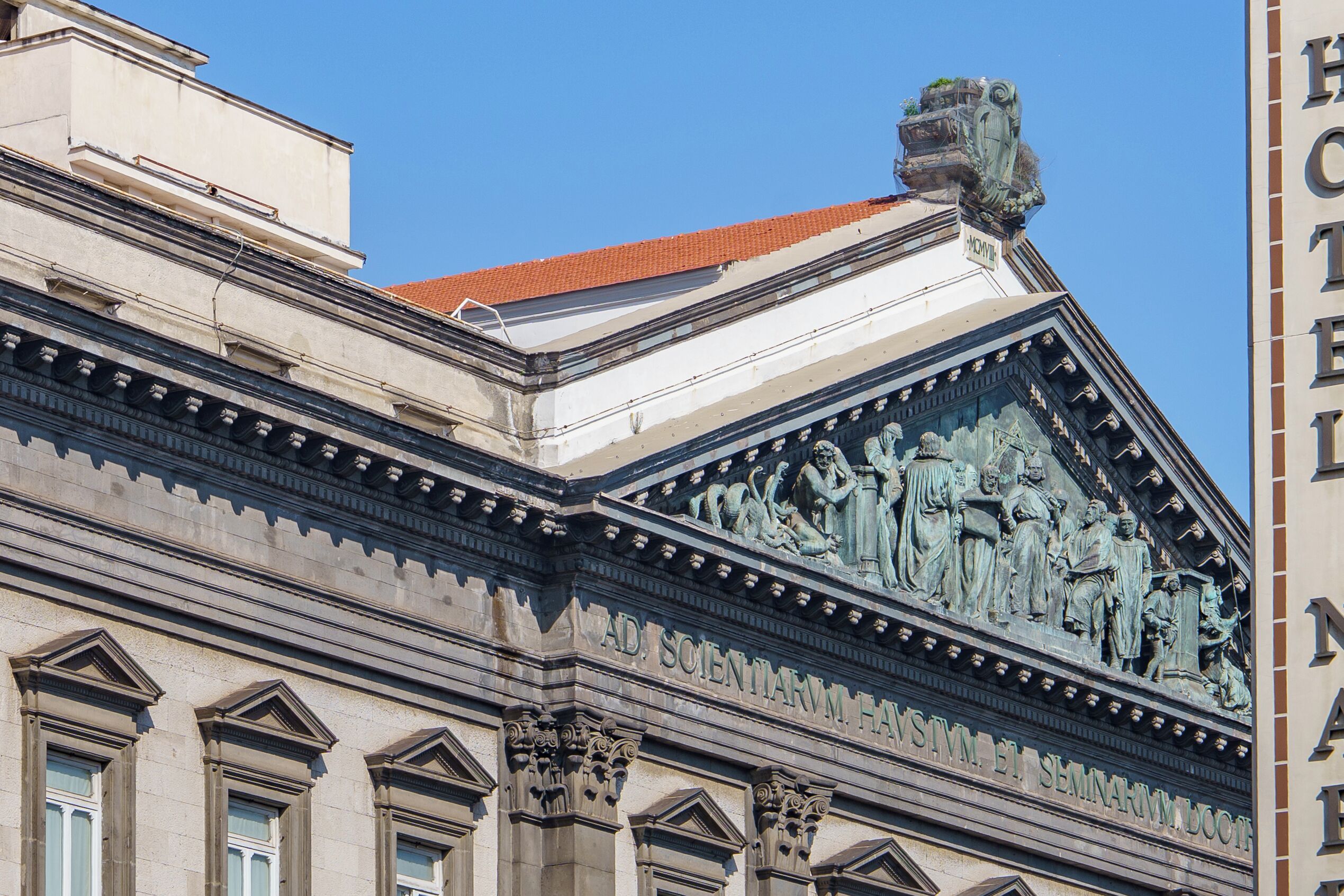 A building with classical architectural elements, including columns and detailed sculptures.