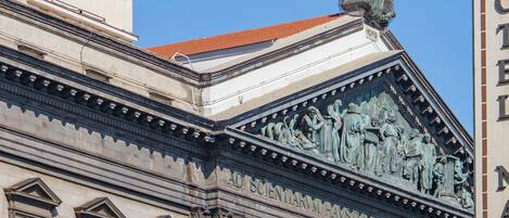 A building with classical architectural elements, including columns and detailed sculptures.