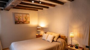 A bedroom with a bed, two bedside tables, a painting, and a lamp. - Holiday Home “Gîte Ithurrondoa” with Private Pool, Terrace & Wi-Fi (Masparraute)
