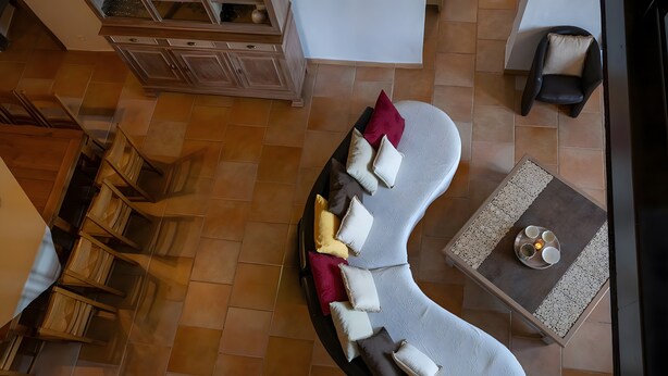 A curved sofa with multiple cushions, a small table with a tray, and a chair. - Holiday Home “Gîte Ithurrondoa” with Private Pool, Terrace & Wi-Fi (Masparraute)