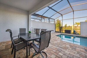 A covered outdoor area with a pool, a table with chairs, and a view of the surrounding landscape. - Private Pool Oasis, Solara Resort,  Stylish Decor (Four Corners)