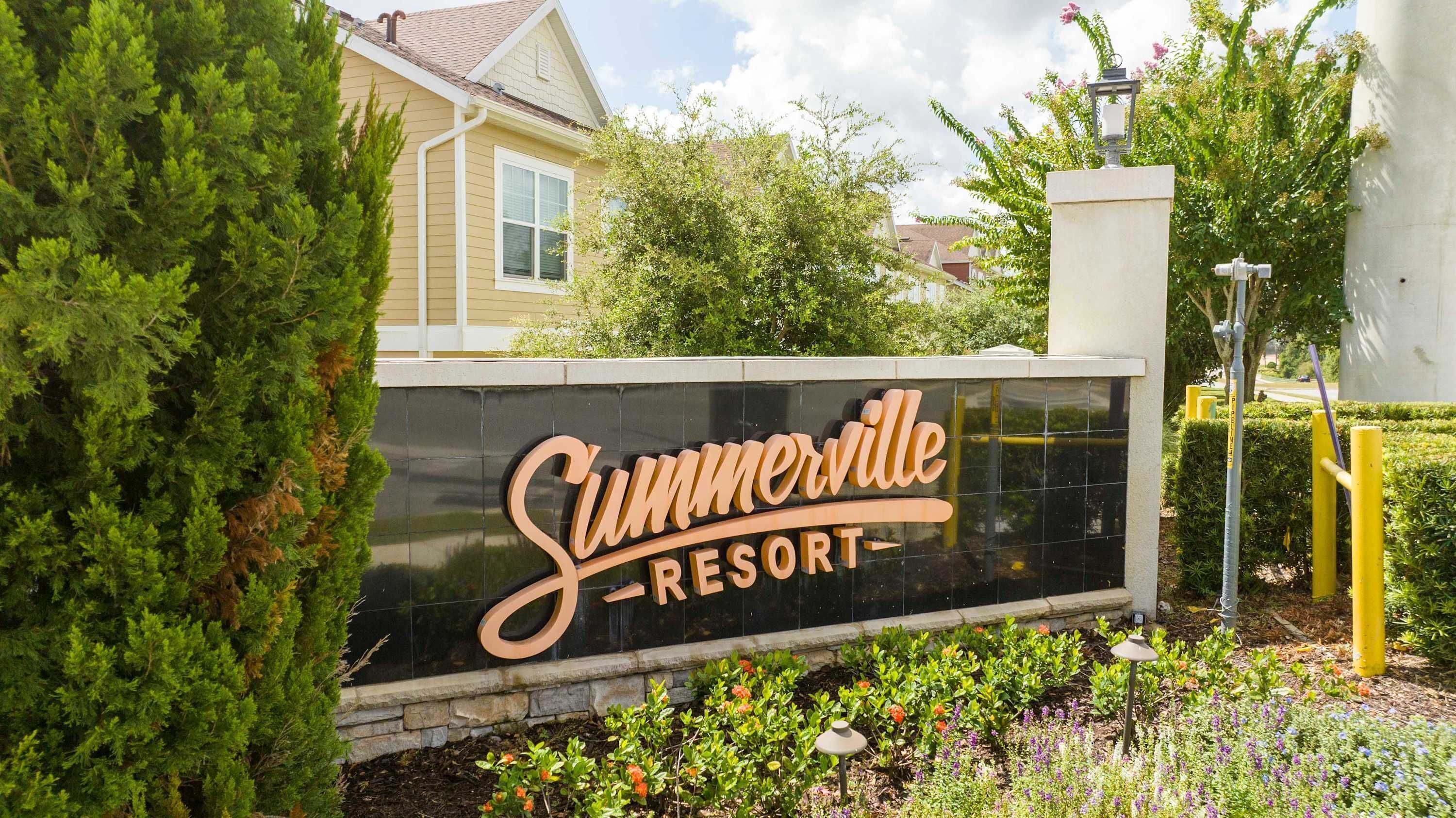 A sign for Summerville Resort with a black background and gold lettering.