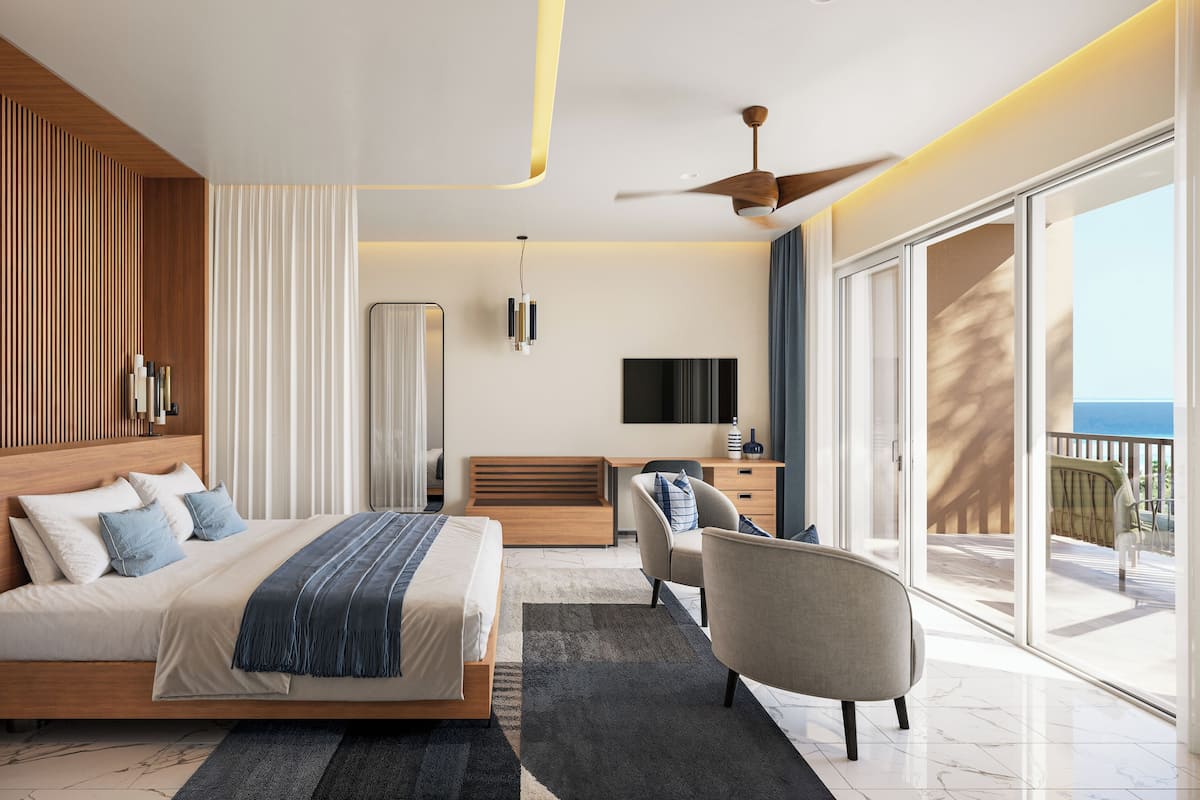 Una habitación de hotel moderna con una cama, un escritorio, una silla, un televisor y un balcón con vistas.