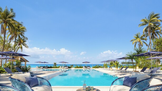 A pool area with lounge chairs and umbrellas, a wooden table with snacks, and a view of the ocean. - Iberostar Selection Zanzibar – All-Inclusive (Matemwe)