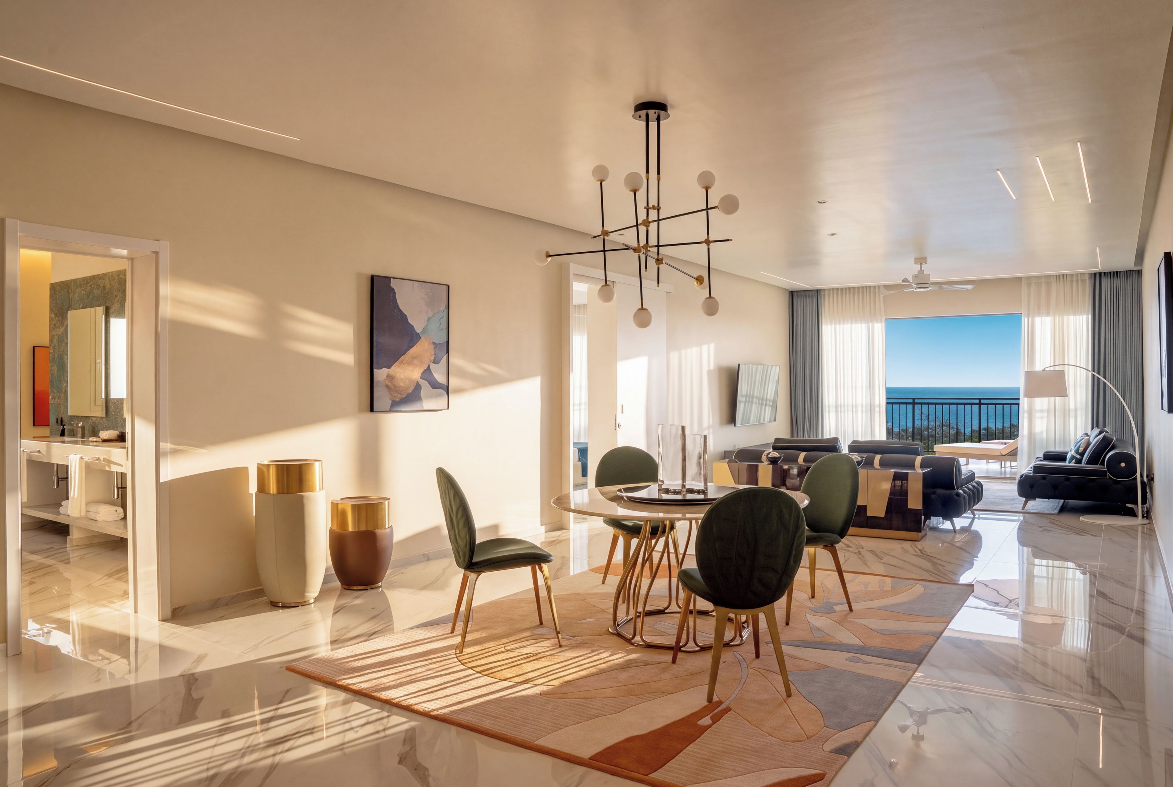 A modern hotel room with a dining area, a living room with a view, and a balcony.