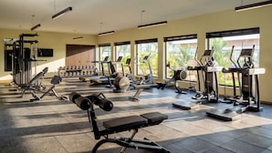 A well-lit gym with various exercise equipment, large windows, and a tiled floor. - Iberostar Selection Zanzibar – All-Inclusive (Matemwe)